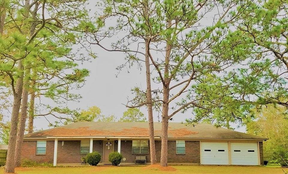Welcome to 6374 Belle Bayou Drive sitting on two lots graced by a number of mature trees and situated on Alligator Bayou.