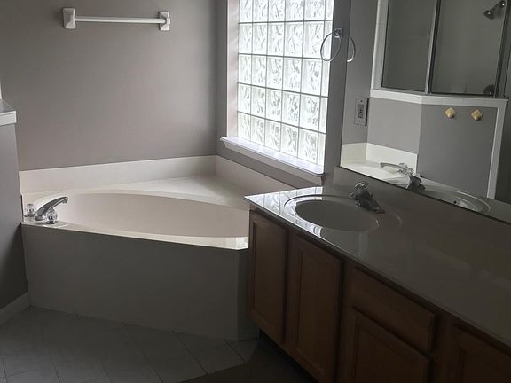 master bath with seperate shower, John closet and walk-in closet