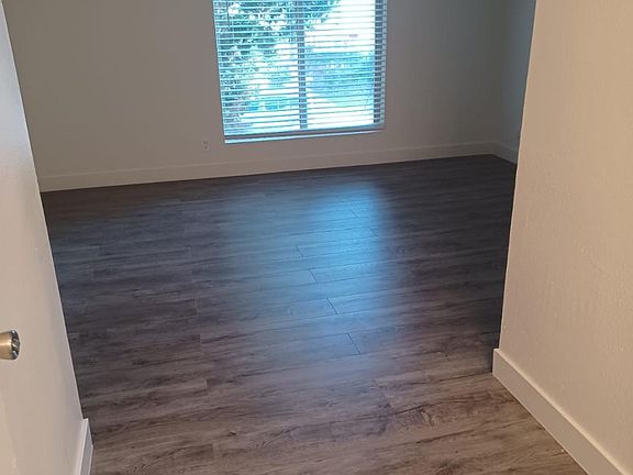 This is one of two bedrooms, large windows, walk in closet, vanity area.