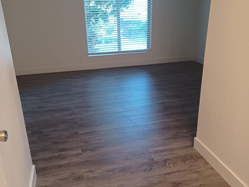 This is one of two bedrooms, large windows, walk in closet, vanity area.