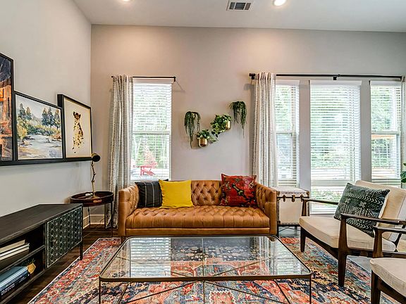 Contemporary Apartment Living Space with Art Display and Wood-Style Floors
