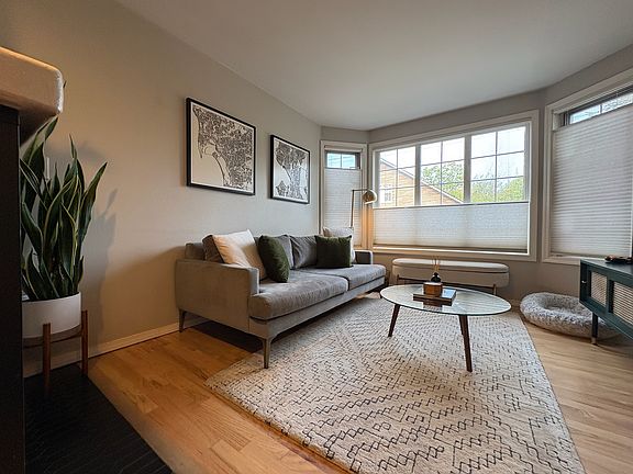 View of the living room from the kitchen featuring bay windows and top down bottom up cellular blinds