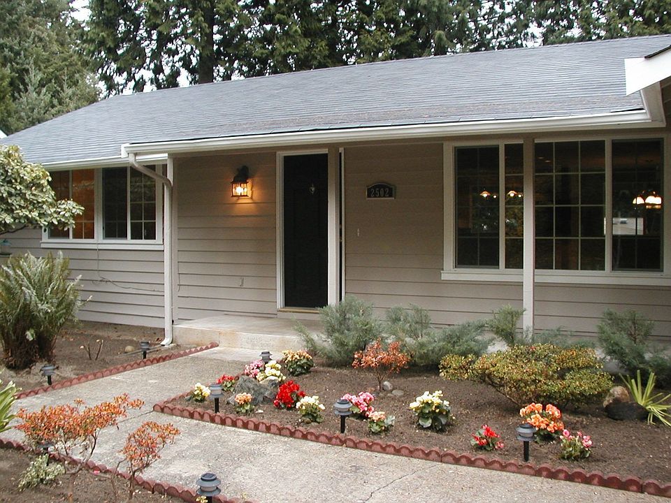 Beautiful landscaping graces the entry to the home