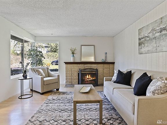 The large corner windows fill the room with ample sunlight.