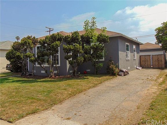 View of long driveway leading to 2 car detached garage