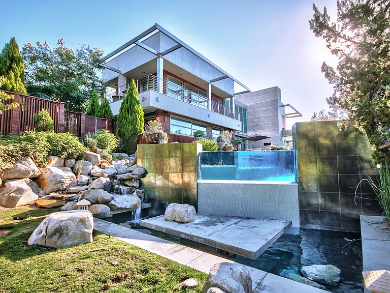 infinity edge glass pool with warerfall