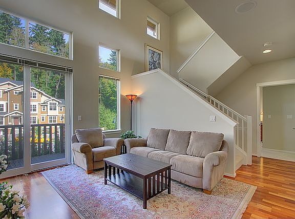 2-story living room, surrounded by walls of windows