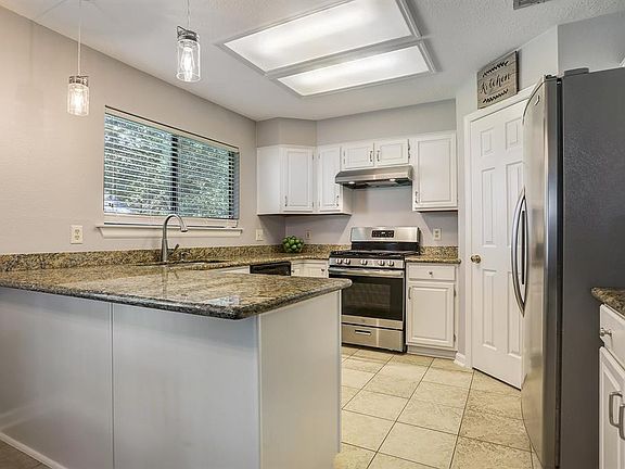 This gorgeous kitchen has granite counter tops, updated fixtures, and a walk in pantry.