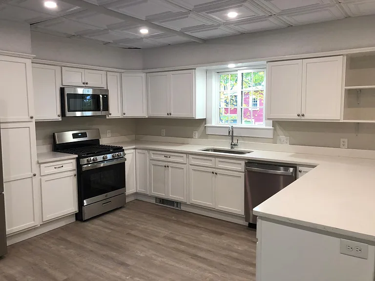 Huge kitchen with new appliances. Gas range. Toe-heater in baseboard by sink.