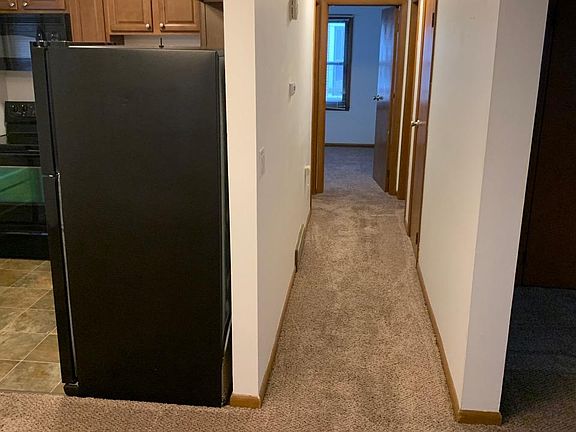 Kitchen on left, hallway straight ahead, living room on right