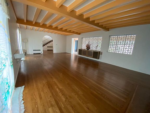 Looking at the foyer and stairs from the far side of the living room.