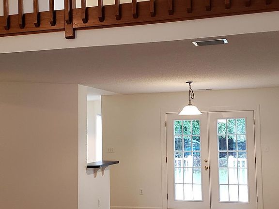 Dining area w/ loft above and access to deck