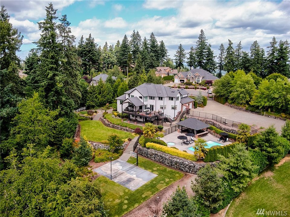 Picturesque resort-style property in sought after Edgewood location features a privately gated entry, professionally designed la