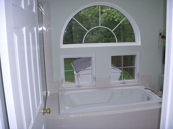 Large master bathroom with catherdral ceiling and skylight