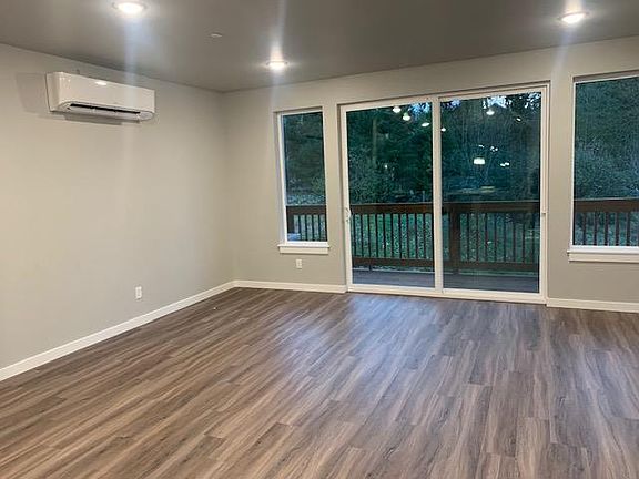 Main level offers spacious Great Room with Vinyl plank floors. Large slider opens to covered Deck overlooking greenbelt. Note the efficient ductless mini-split HVAC system offering A/C for Summer comfort.