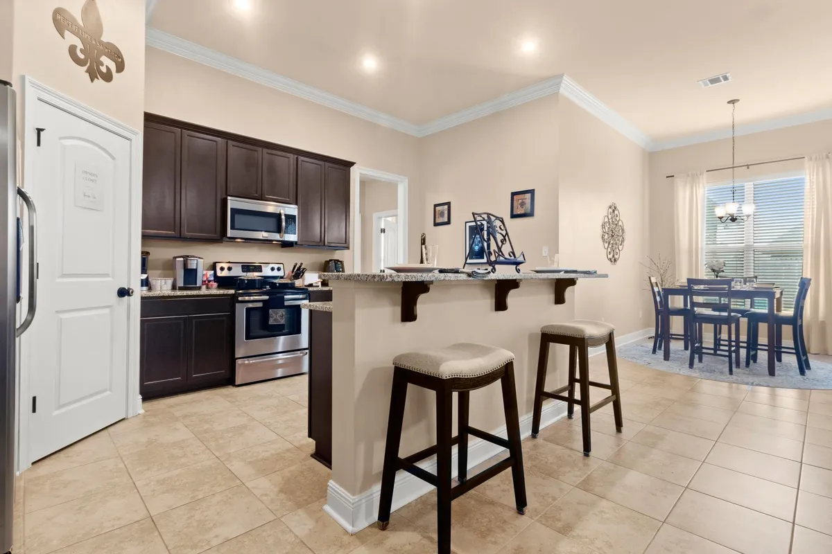 The kitchen island allows for dining space for up to three guests. - Thibodeaux Rd