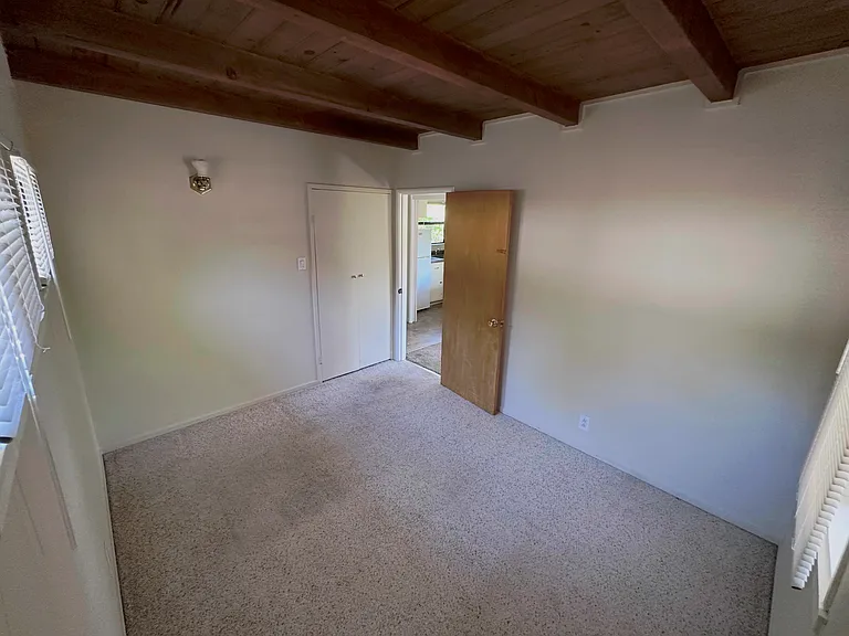 Bedroom with the closet door next to the entry door for the bedroom