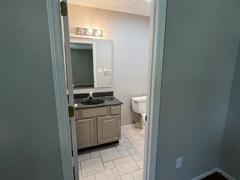 first bedroom with an en suite 1/2 bath