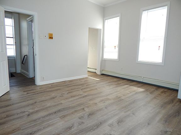 LIVING ROOM FACING EXIT AND KITCHEN