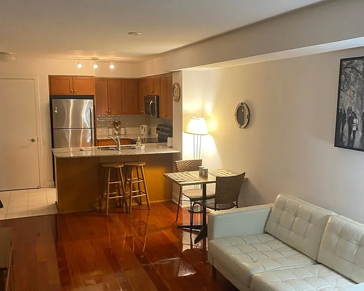 View from sliding door/glassed wall at end of living room to entrance area, kitchen and one side of the living room space