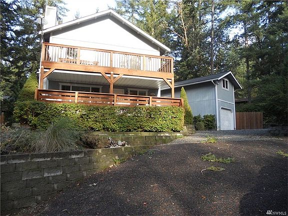 Street view of home and garage. Notice finished landscape with drought resistant plants.