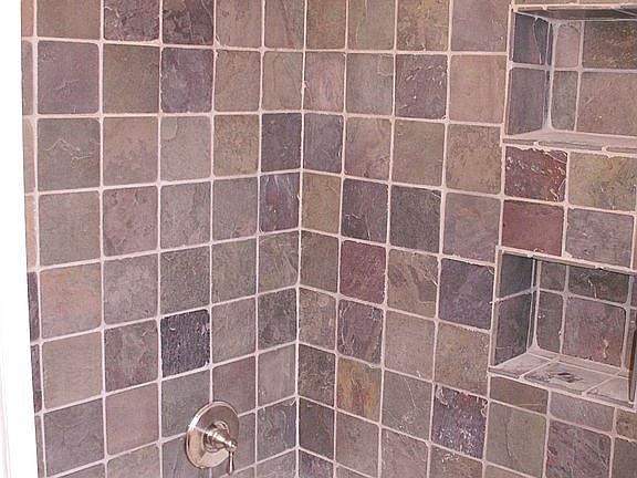 Slate tiled shower enclosure