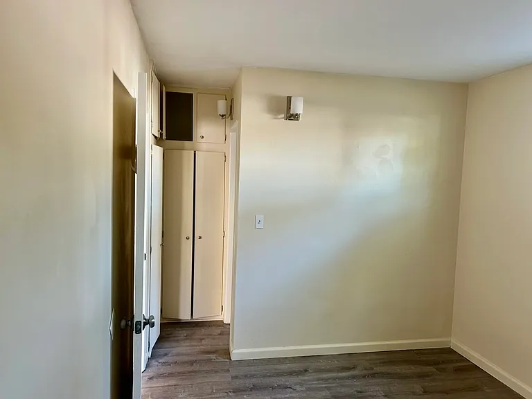 Bedroom looking toward bathroom hallway with build in closet area.