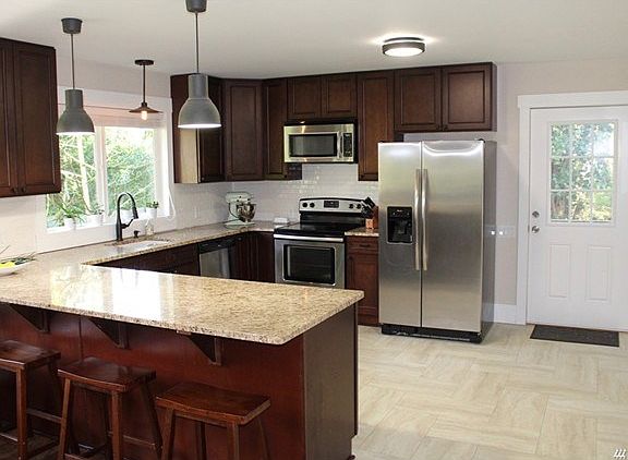 You have to love this kitchen, complete with slab granite counters, new kitchen cabinets and stainless appliances.