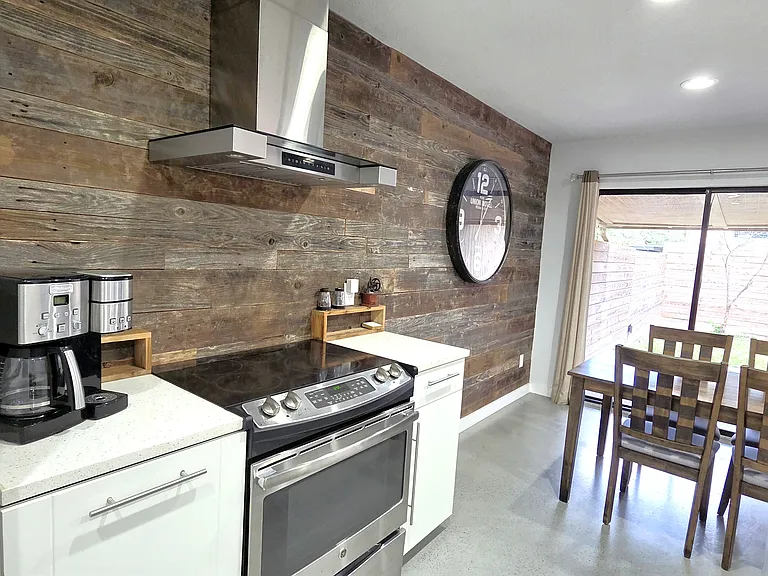 Kitchen and Dining area with wood accent wall
