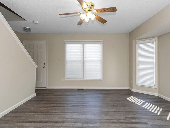 Living Room with brand new flooring, white blinds & ceiling fan
