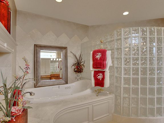 Relax in the Jacuzzi by the FP or bathe in your HUGE glass block shower!