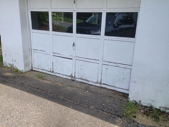 One car garage with garage door remote.