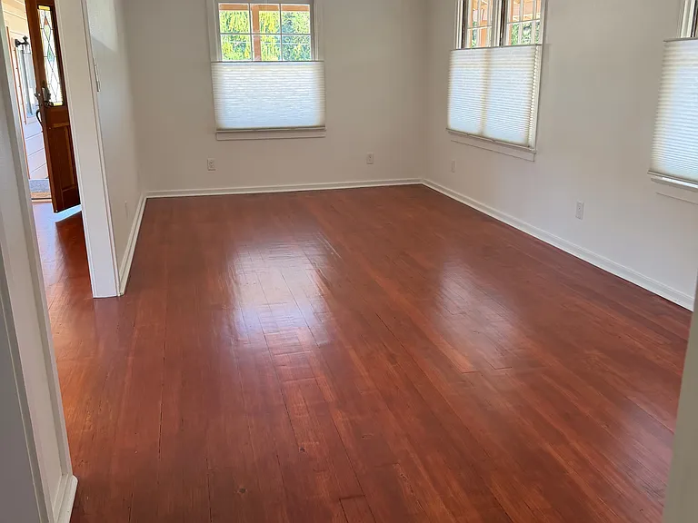 Large living room can comfortably seat a U shaped couch, TV and dining table