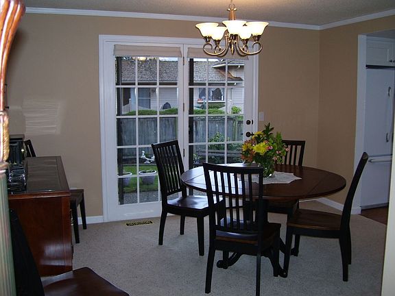 Formal dining with elegance; French doors out to the deck.