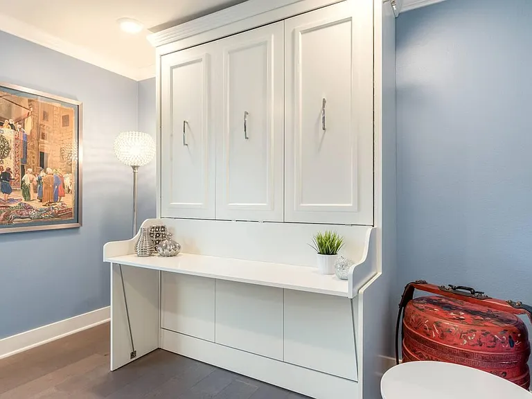 This is actually a hidden wall bed which converts the office into a practical guest bedroom.