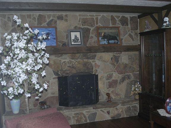 Family Room, stone fireplace & beamed ceiling.