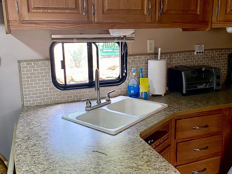 Rear kitchen offers amble counter space and there is ample storage.