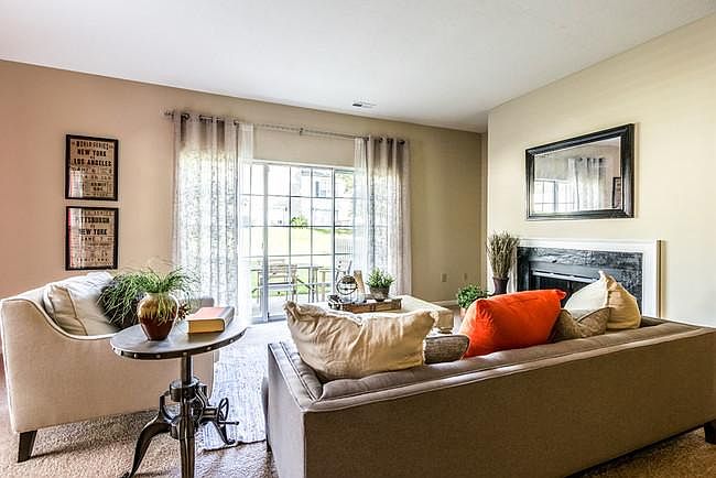 Living room with fireplace and large windows to the outside