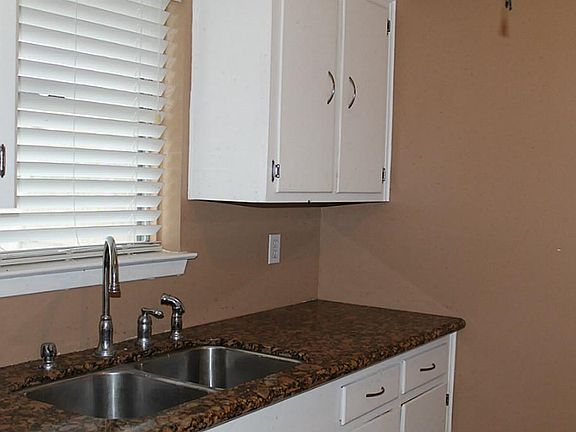 Window looking into backyard, blinds throughout - cute kitchen w/under mount stainless sink..