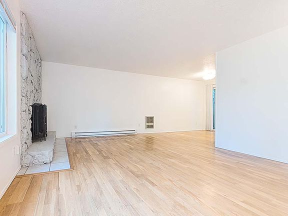 Living room w wood burning fireplace viewed from the front door
