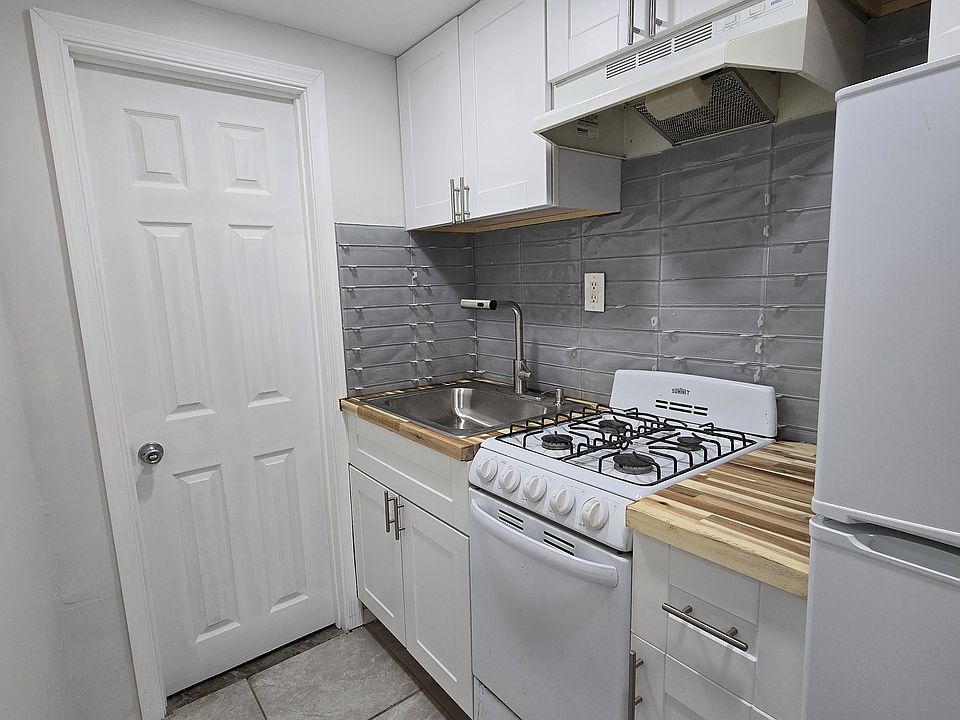 KITCHEN WITH DOOR TO LAUNDRY ROOM AND ADDITIONAL STORAGE