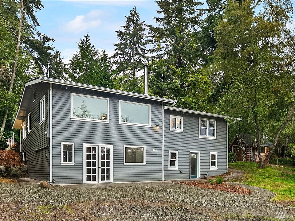 Brand new, freshly painted siding for this lovingly renovated cottage. The lower level is all shop/studio space with two entrances. Main entrance is around to the right. Cute shingled garden shed will be so useful!