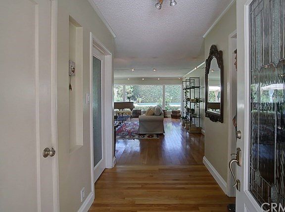 Welcoming entry with views traveling to the back yard through large picture windows