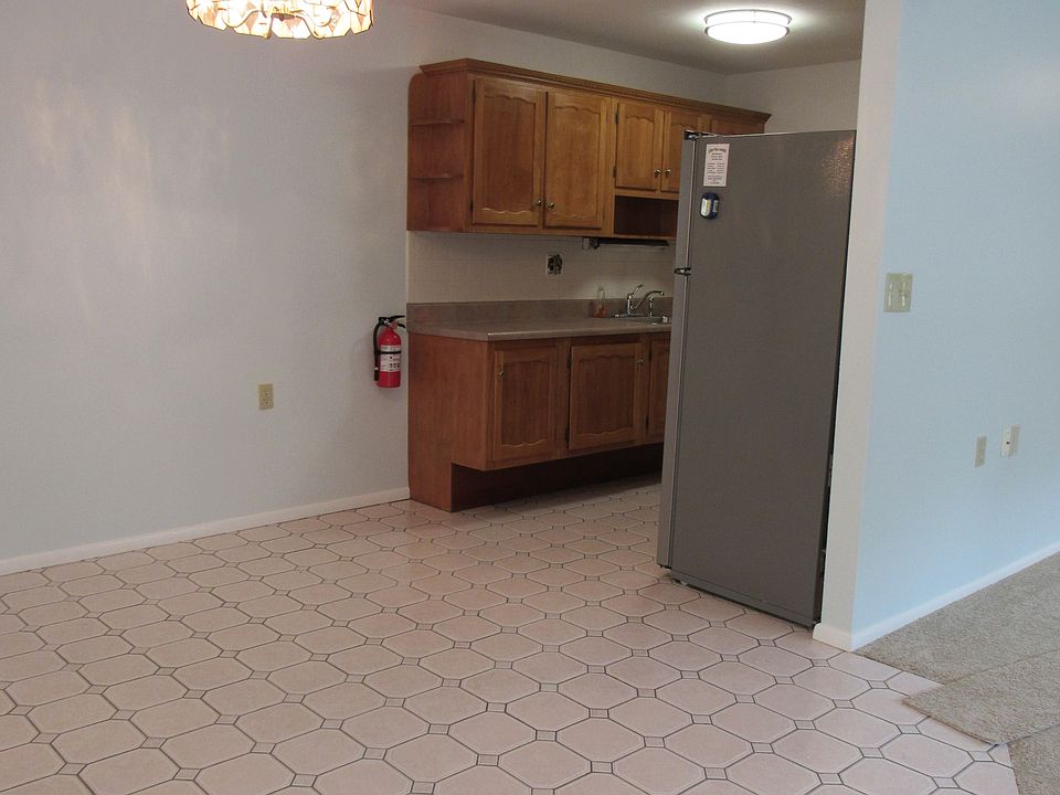 Showing dining area and Gally Kitchen. 
Flooring in Livingroom (Inline with wall) has been replaced with Hardwood Flooring (Gray/Blue Tone) Still leaves nice tiled dining area