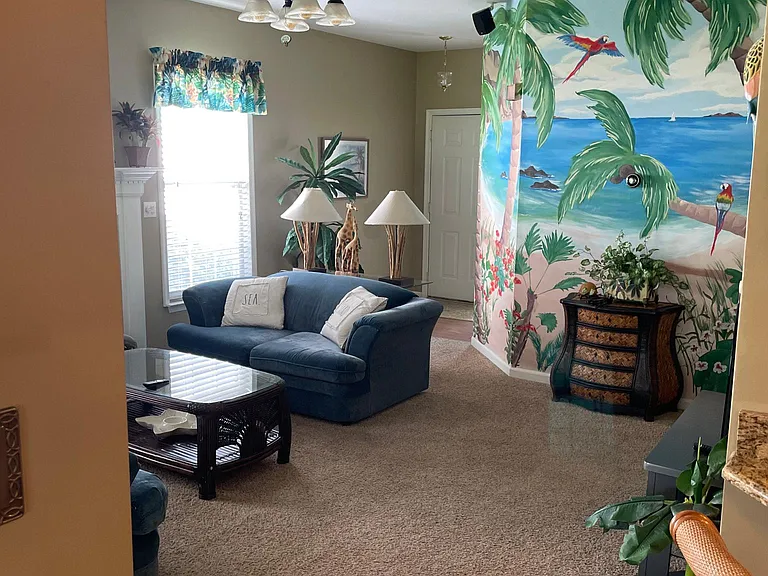 Living room with 50" smart TV, propane fireplace (winter only), couch and loveseat