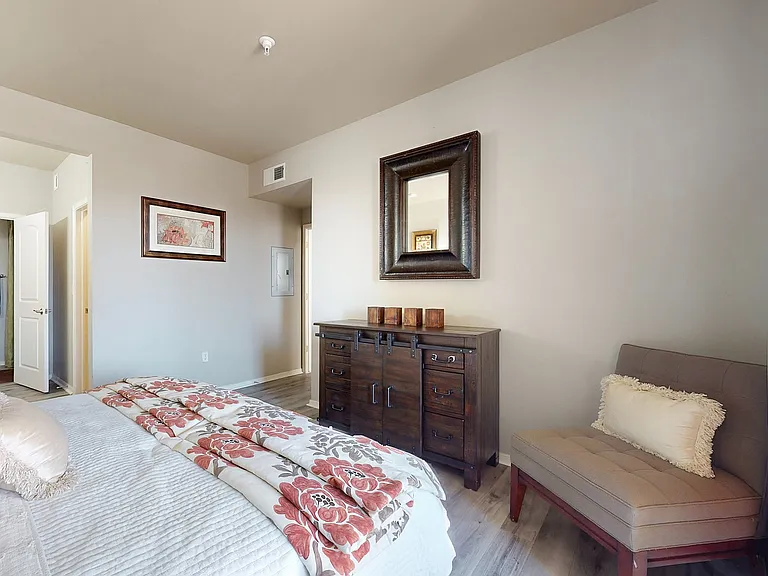 Experience tranquility in this elegantly styled bedroom, featuring tasteful decor and inviting comfort.