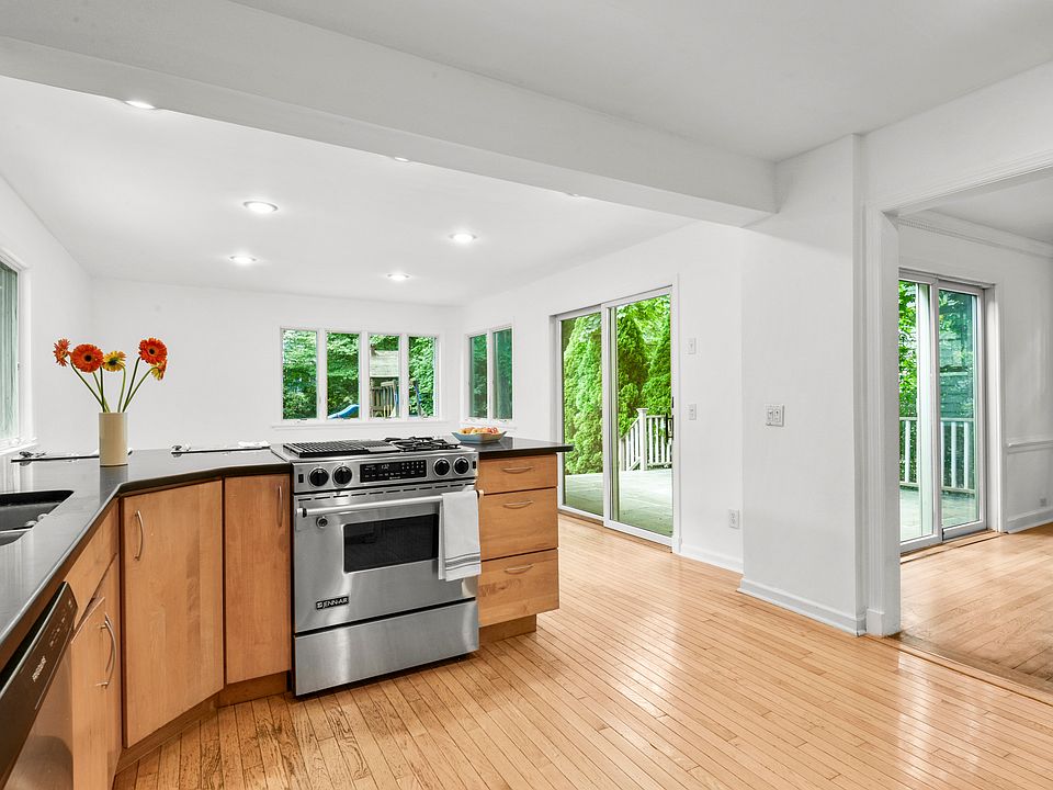 The kitchen, truly the heart of the home, flows seamlessly into the adjacent family room and opens through sliding doors to the patio and the backyard, ideal for entertaining.