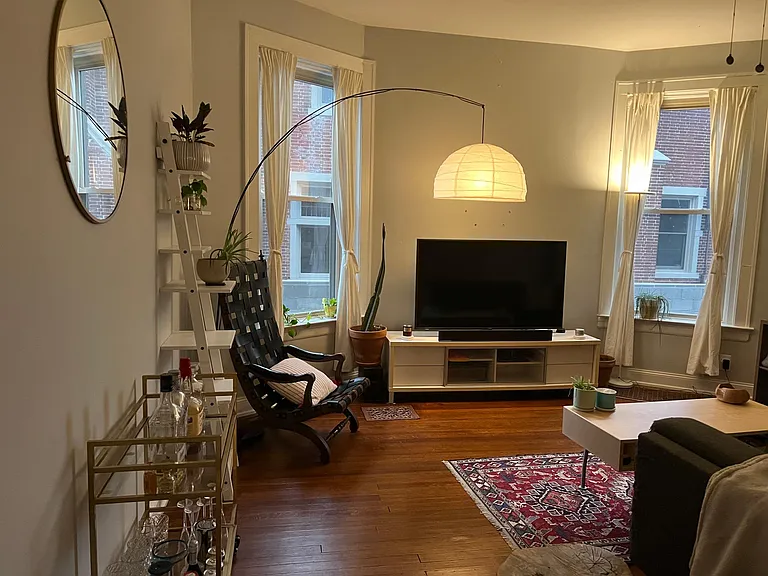 Living room with 12 foot ceilings and refinishing original hardwood floors