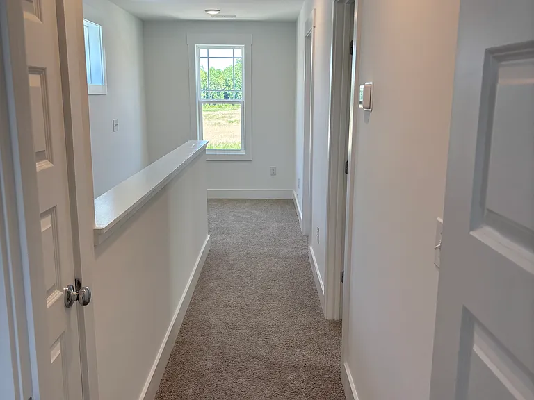 hallway - note the flex space at the top of the stairs with lots of natural light - perfect for a small chair and reading nook or small desk