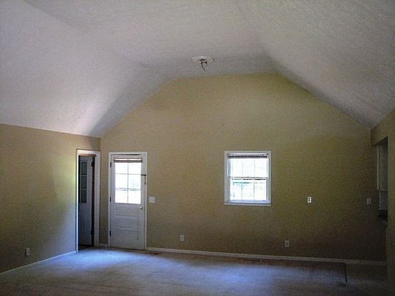 Other end of great room is for dining (open to kitchen) and opens through the back door to the deck 